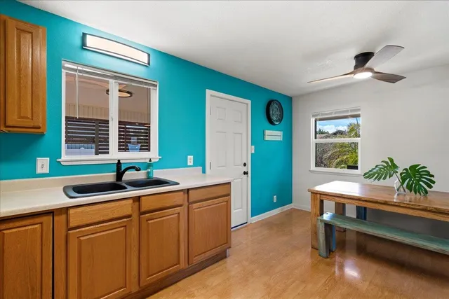 a kitchen with a sink cabinets and window