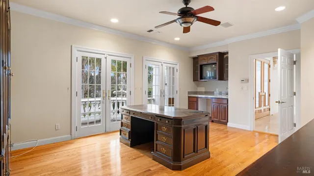 a view of a white house with a large garage and large windows