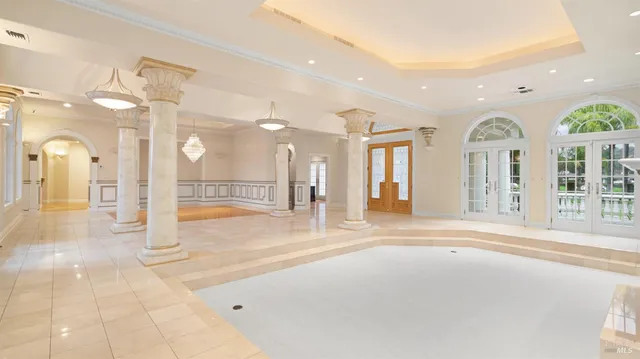 a large kitchen with kitchen island a stove a sink a refrigerator and wooden floor