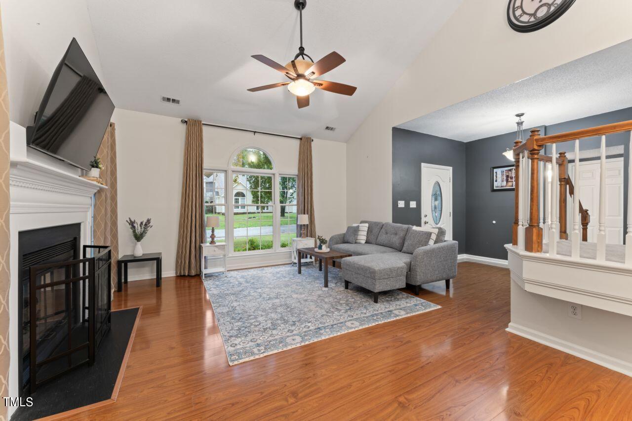 12129 Mabledon Court Raleigh, NC 27613 - Photo 11 of 31 a living room with furniture and a flat screen tv