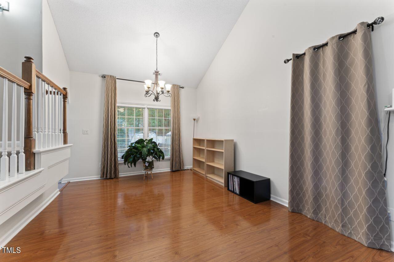 12129 Mabledon Court Raleigh, NC 27613 - Photo 12 of 31 a view of a livingroom with wooden floor fireplace and a window