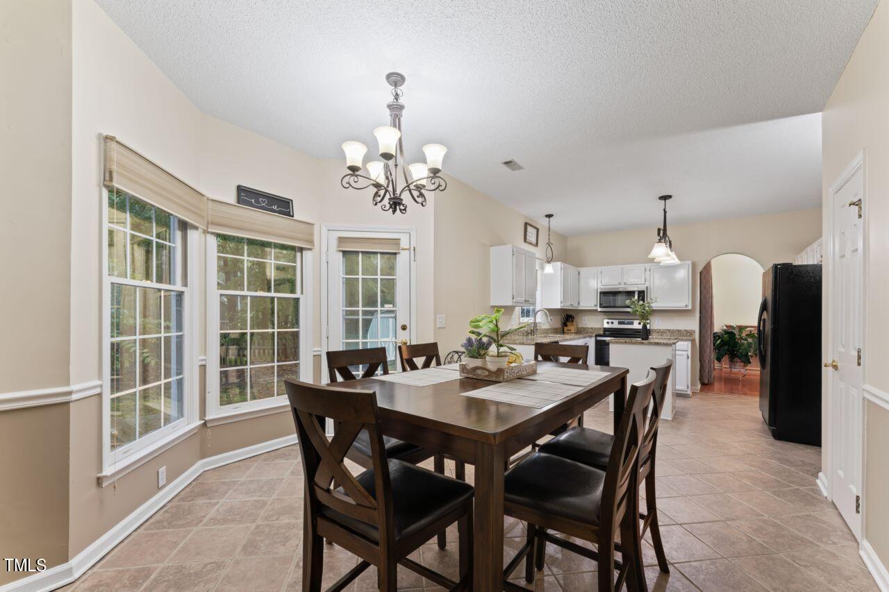 12129 Mabledon Court Raleigh, NC 27613 - Photo 15 of 31 a view of a dining room with furniture window and outside view