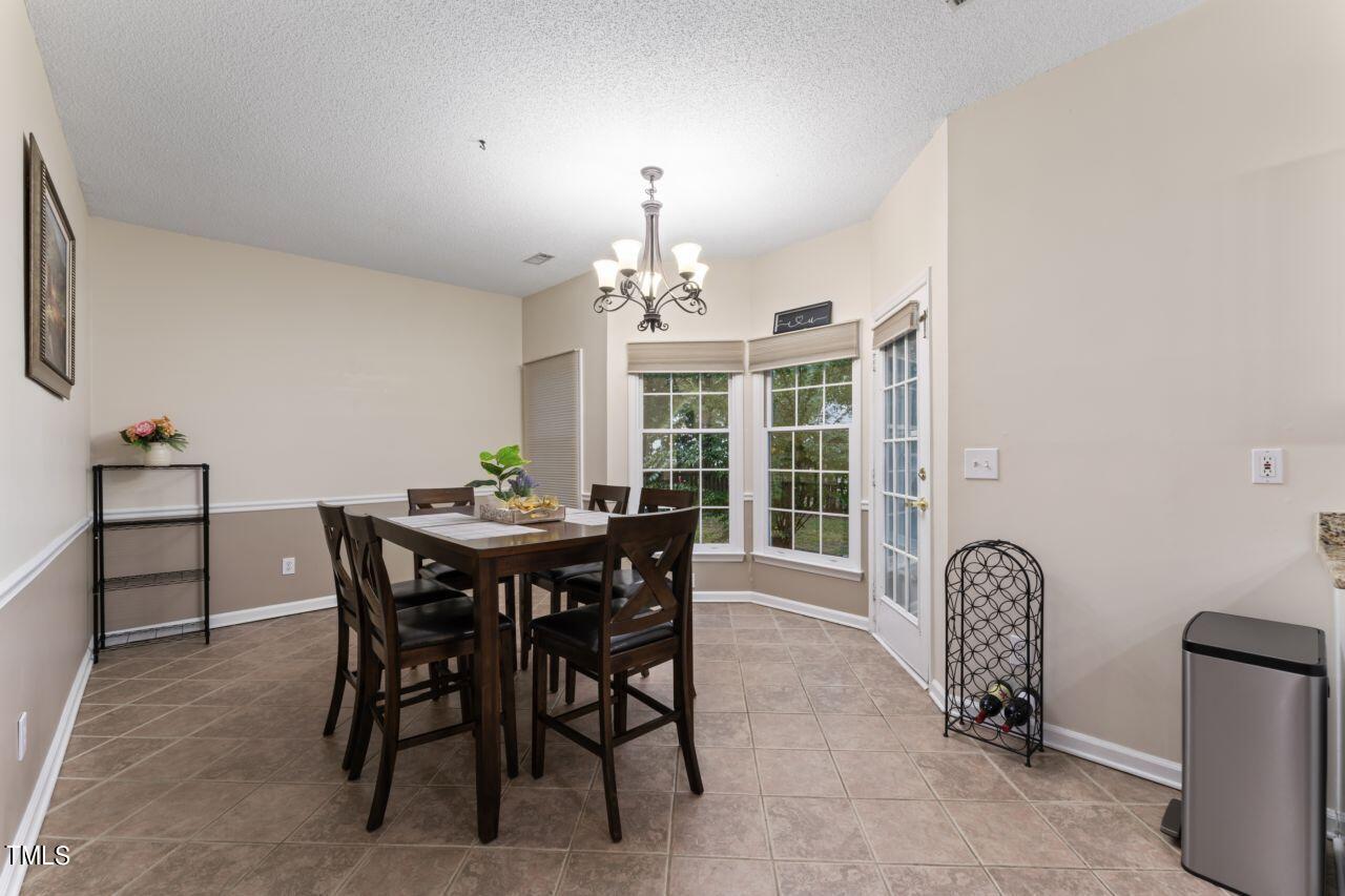 12129 Mabledon Court Raleigh, NC 27613 - Photo 17 of 31 a view of a dining room with furniture and window