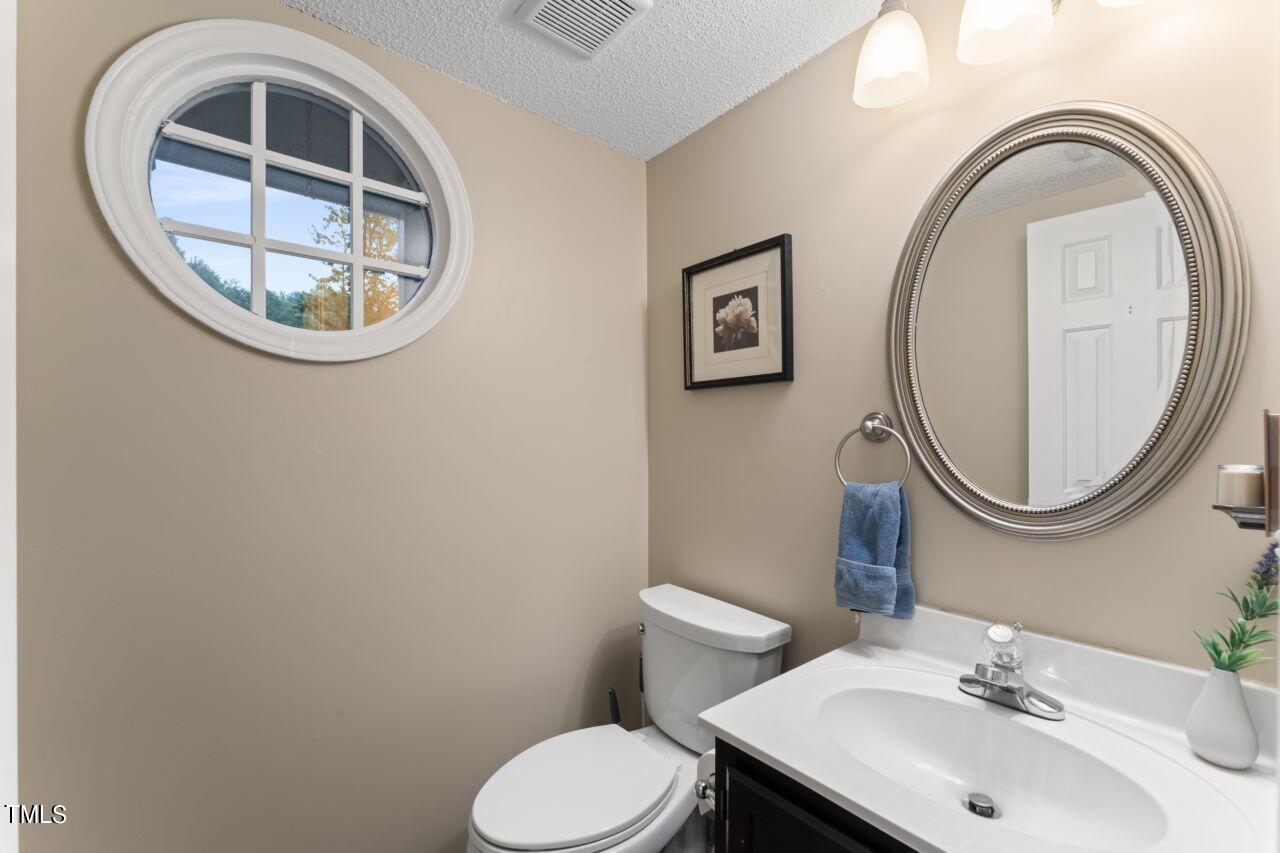 12129 Mabledon Court Raleigh, NC 27613 - Photo 18 of 31 a bathroom with a toilet and a sink