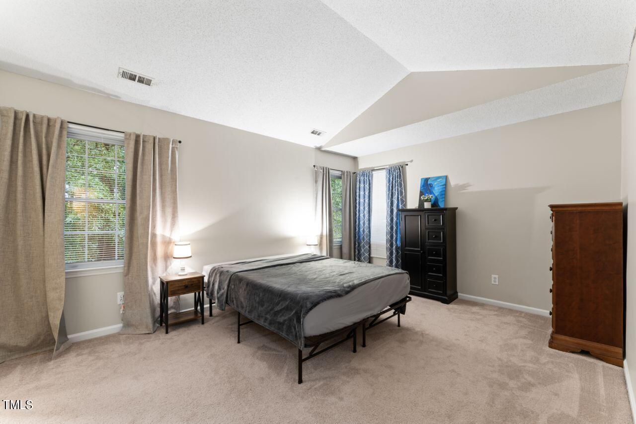 12129 Mabledon Court Raleigh, NC 27613 - Photo 19 of 31 a spacious bedroom with a bed and window