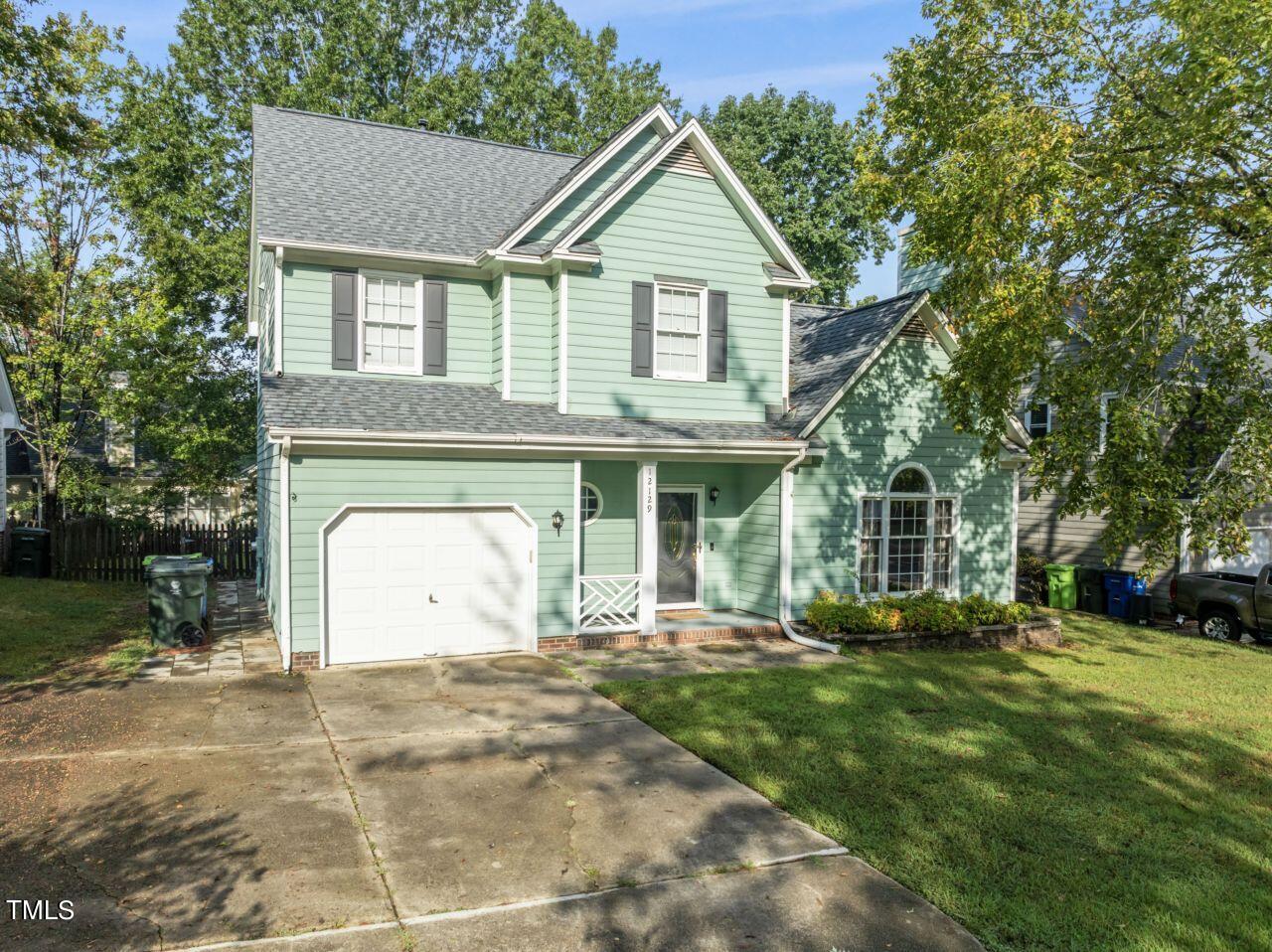 12129 Mabledon Court Raleigh, NC 27613 - Photo 2 of 31 a front view of a house with a yard and trees