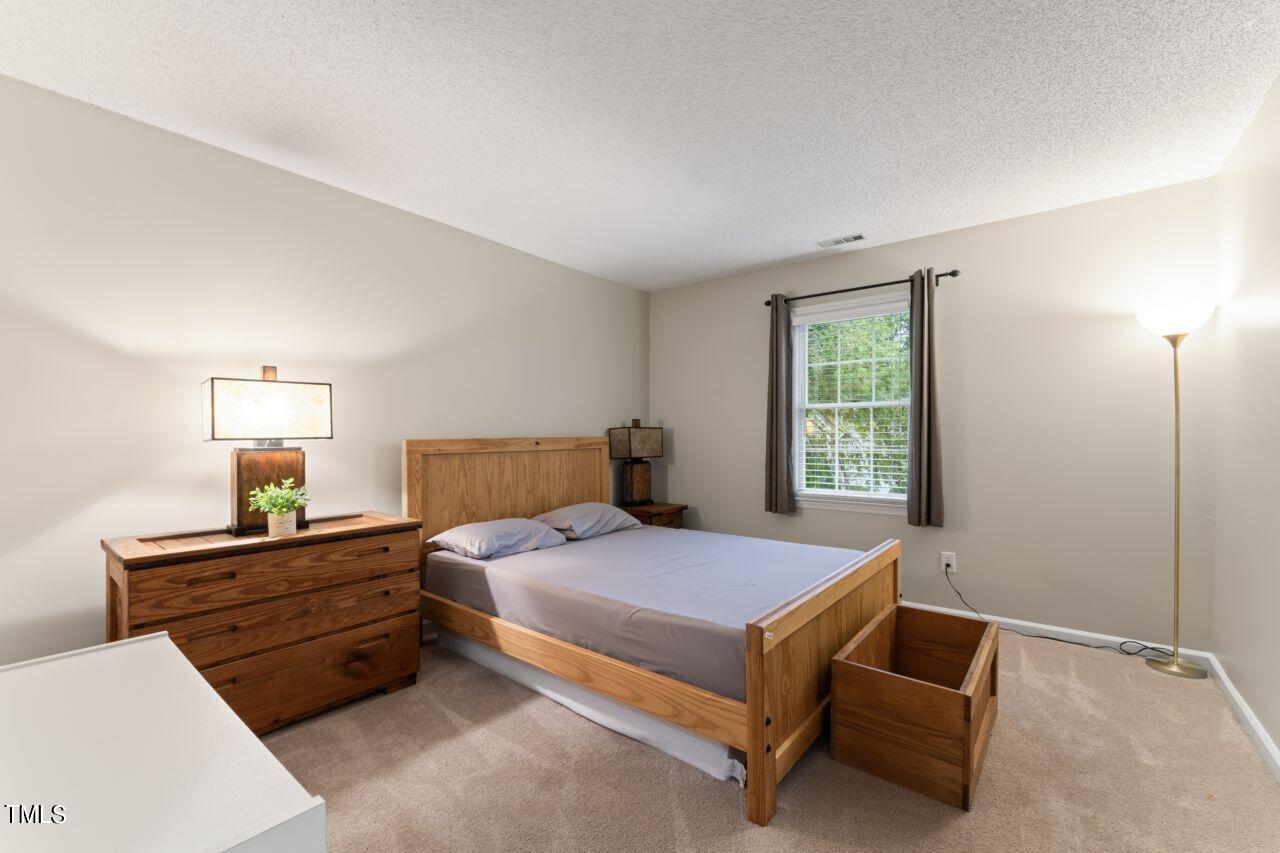 12129 Mabledon Court Raleigh, NC 27613 - Photo 23 of 31 a bedroom with a bed and window