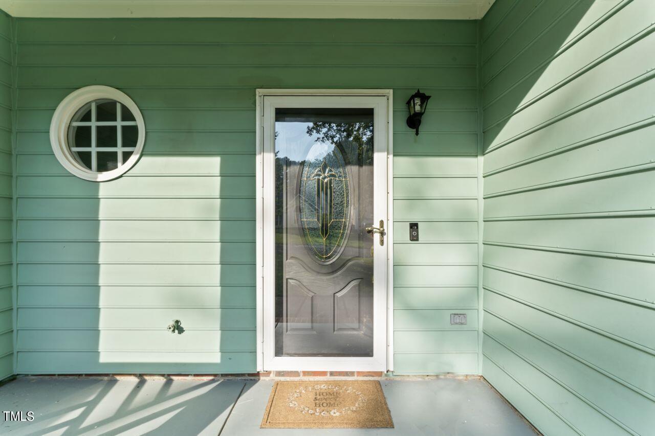 12129 Mabledon Court Raleigh, NC 27613 - Photo 5 of 31 a front view of a house with a glass door