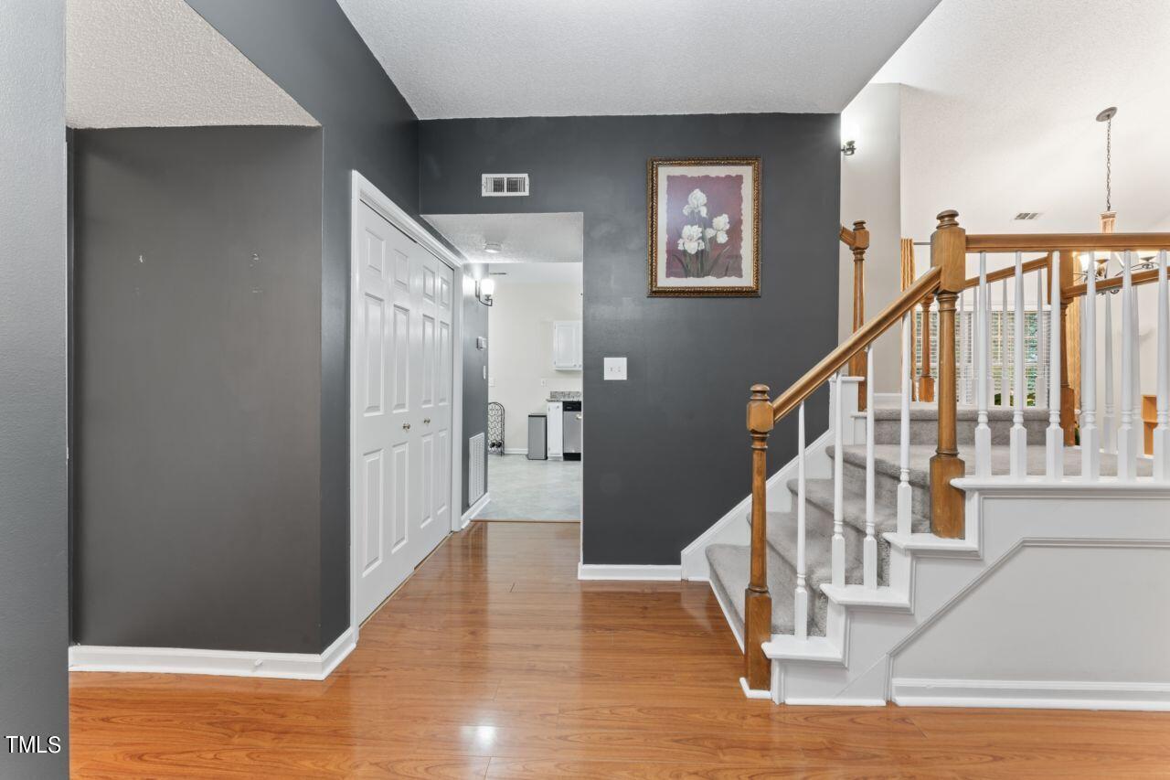 12129 Mabledon Court Raleigh, NC 27613 - Photo 7 of 31 a view of entryway and hall with wooden floor