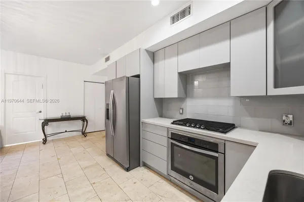 a kitchen with stainless steel appliances a stove a microwave and a refrigerator