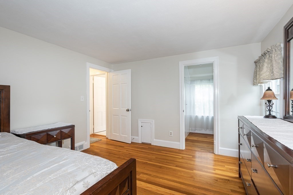 36 Mayfield Street Springfield, MA 01108 - Photo 19 of 34 a bedroom with a bed and wooden floor