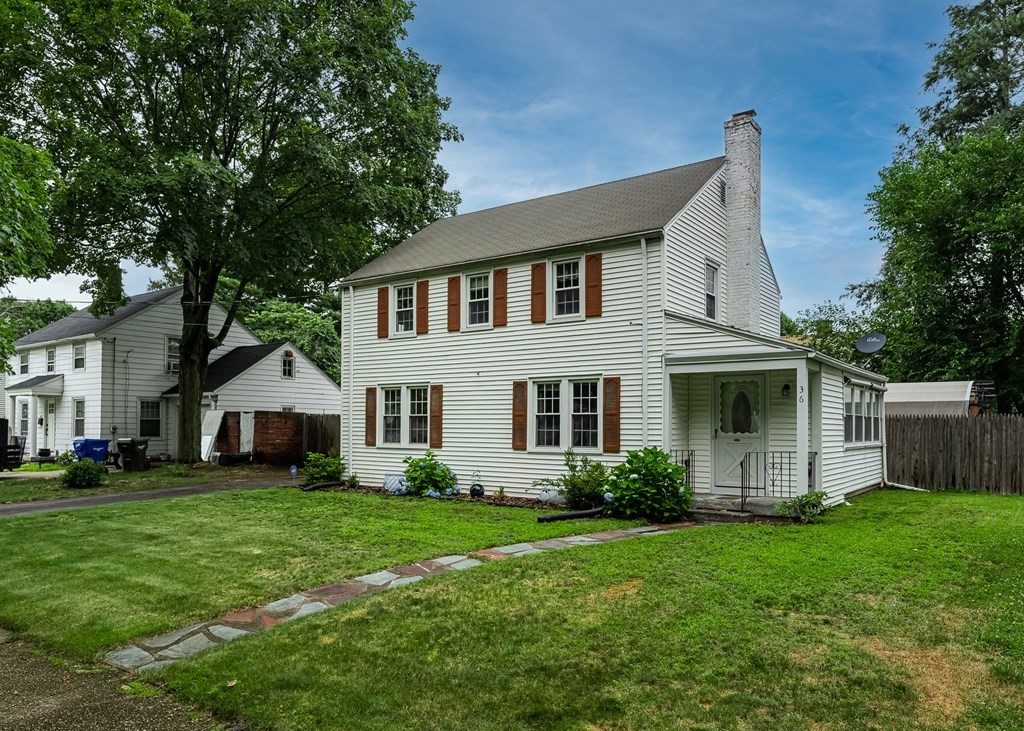36 Mayfield Street Springfield, MA 01108 - Photo 3 of 34 a front view of a house with a garden and trees