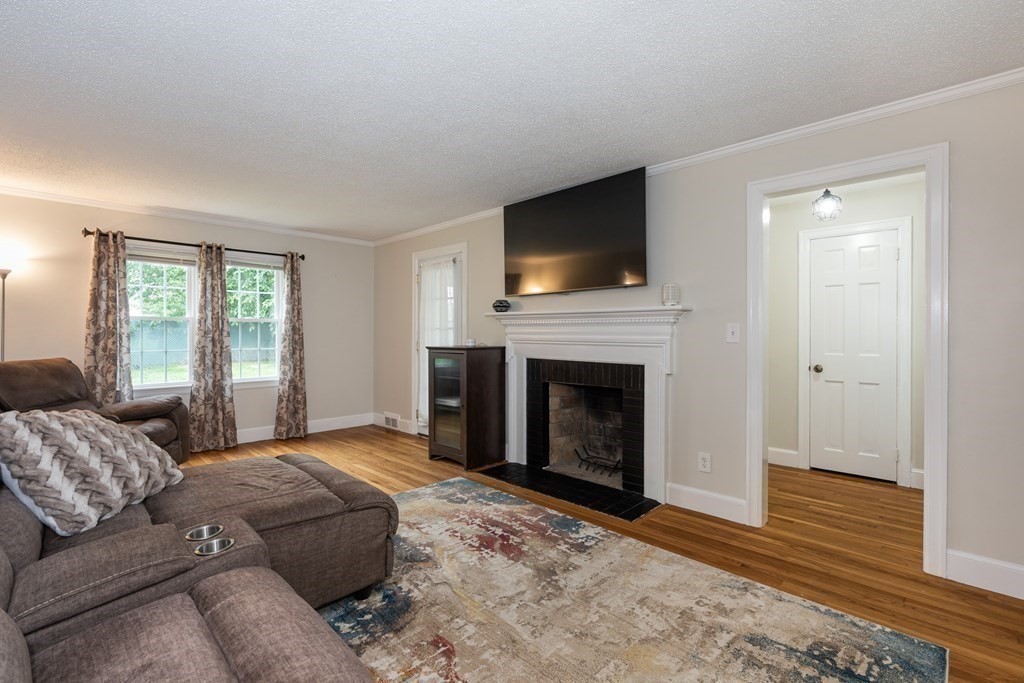 36 Mayfield Street Springfield, MA 01108 - Photo 4 of 34 a living room with furniture a flat screen tv and a fireplace