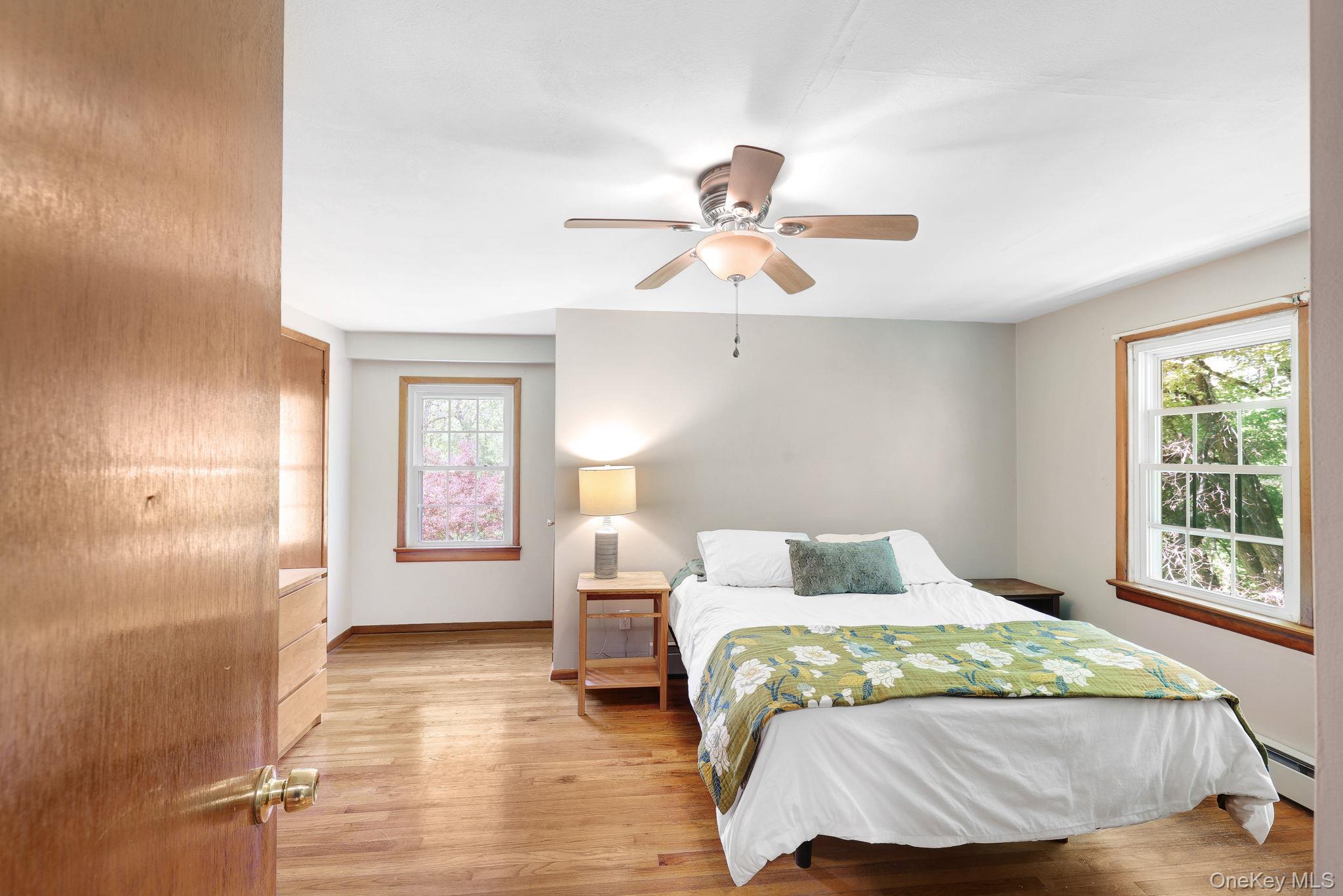 94 Smithtown Road Fishkill, NY 12524 - Photo 36 of 45 a bedroom with a large bed and a chandelier