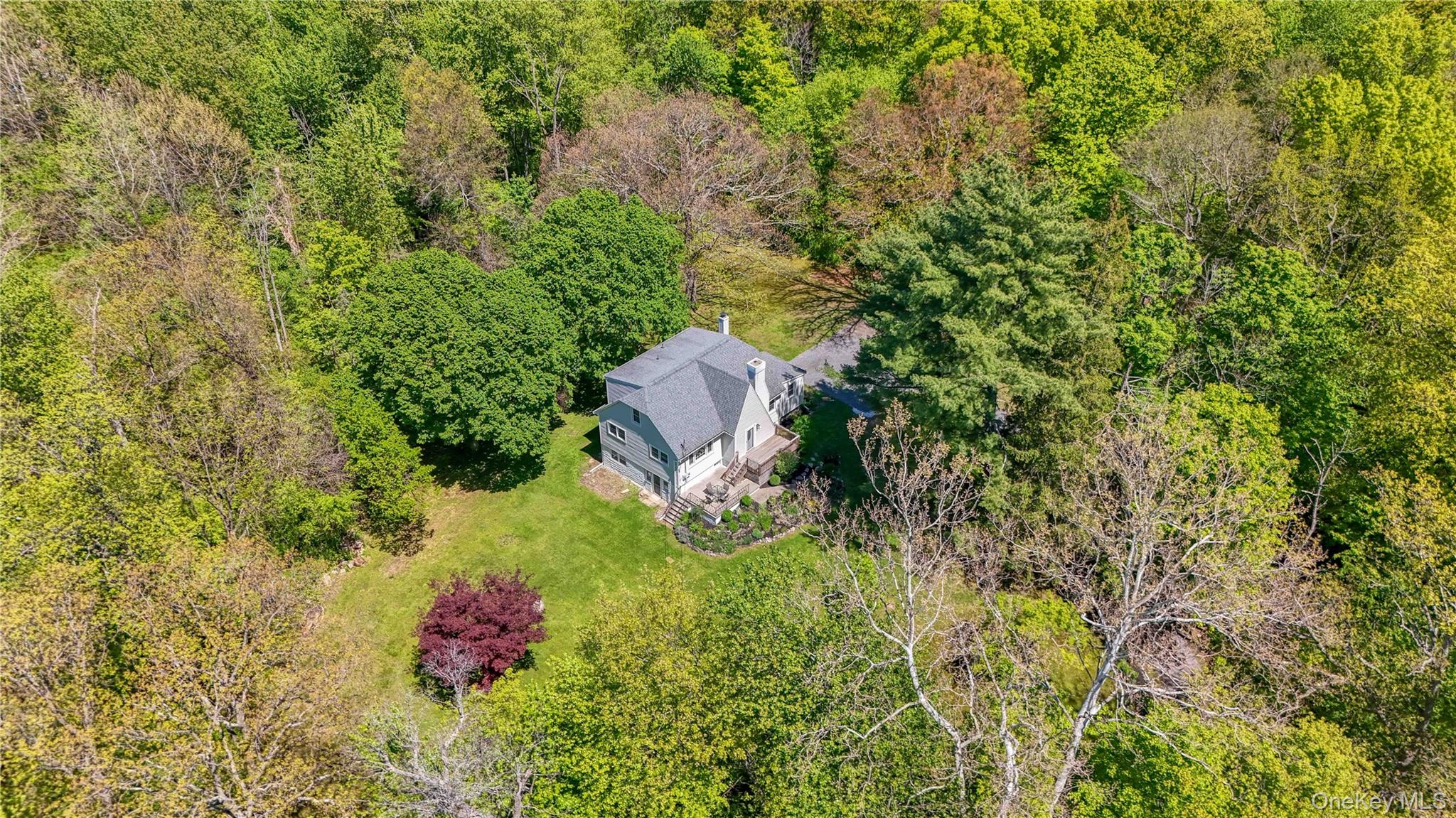 94 Smithtown Road Fishkill, NY 12524 - Photo 5 of 45 a aerial view of a house with a yard and large trees