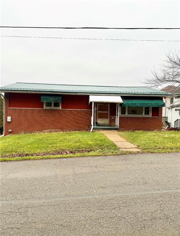 a front view of a house with a yard and a garage