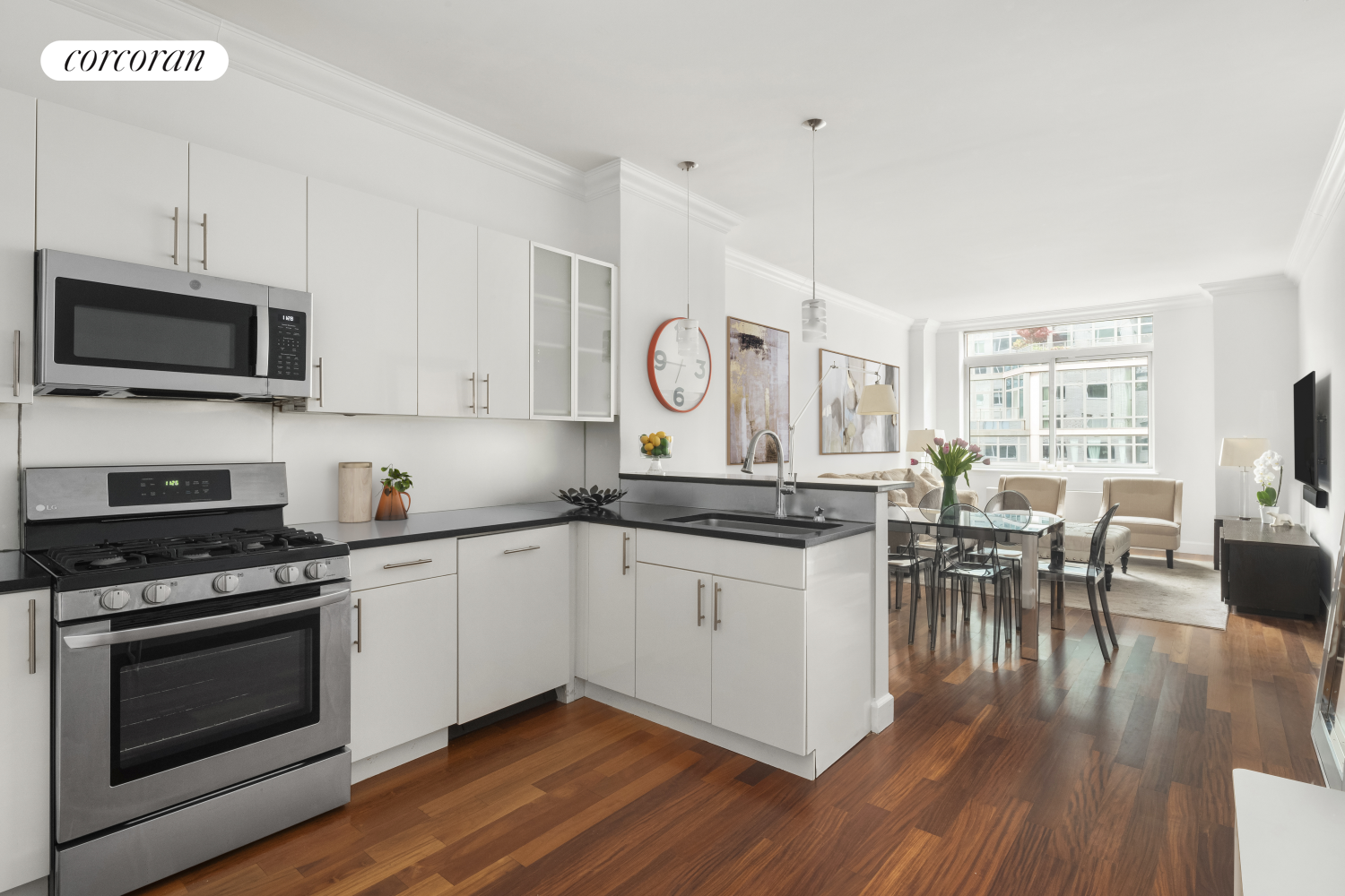 a kitchen with a dining table chairs and stainless steel appliances