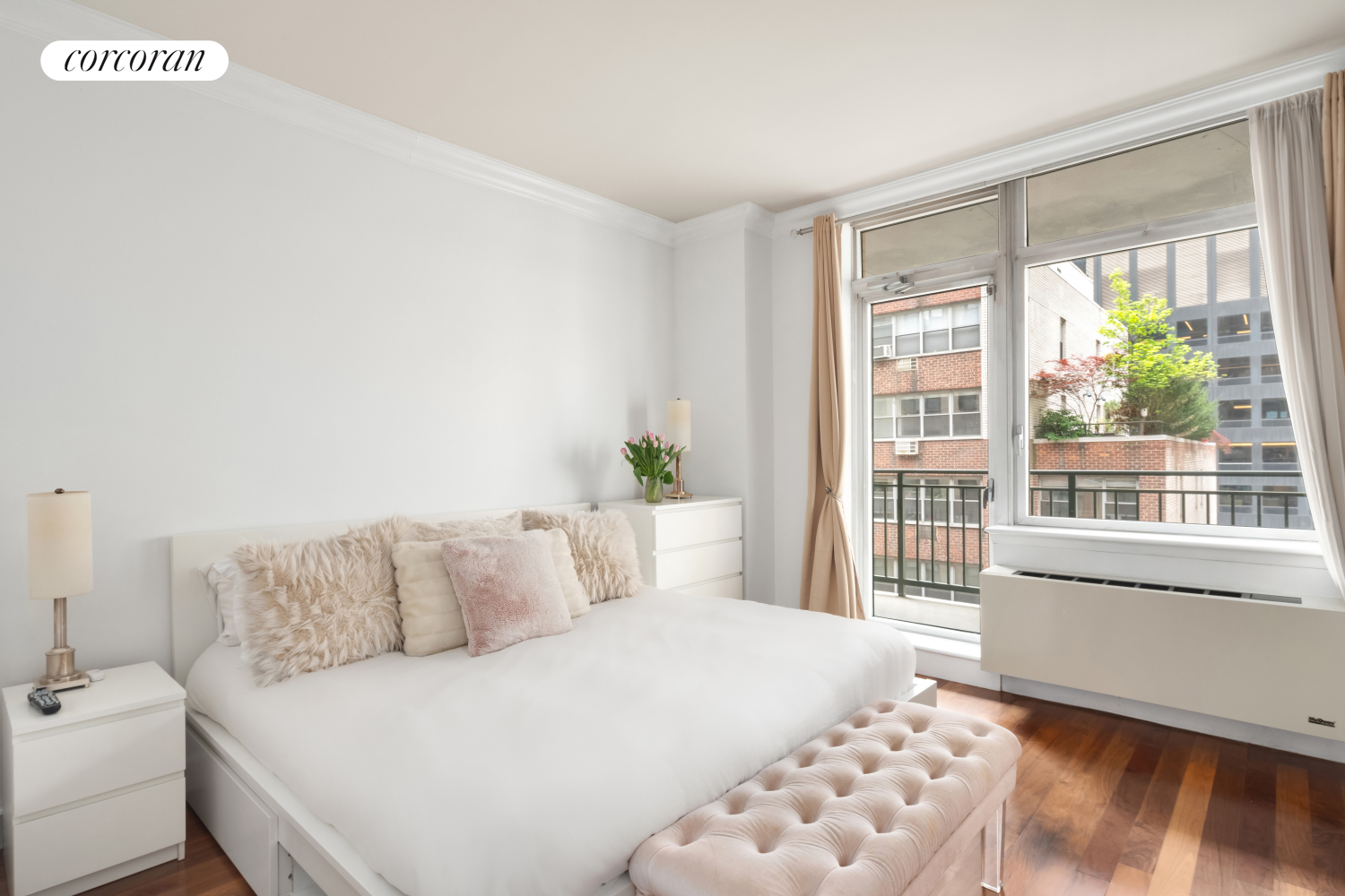 212 East 57th Street, Unit 8C Manhattan, NY 10022 - Photo 5 of 11 a bedroom with a bed and a window