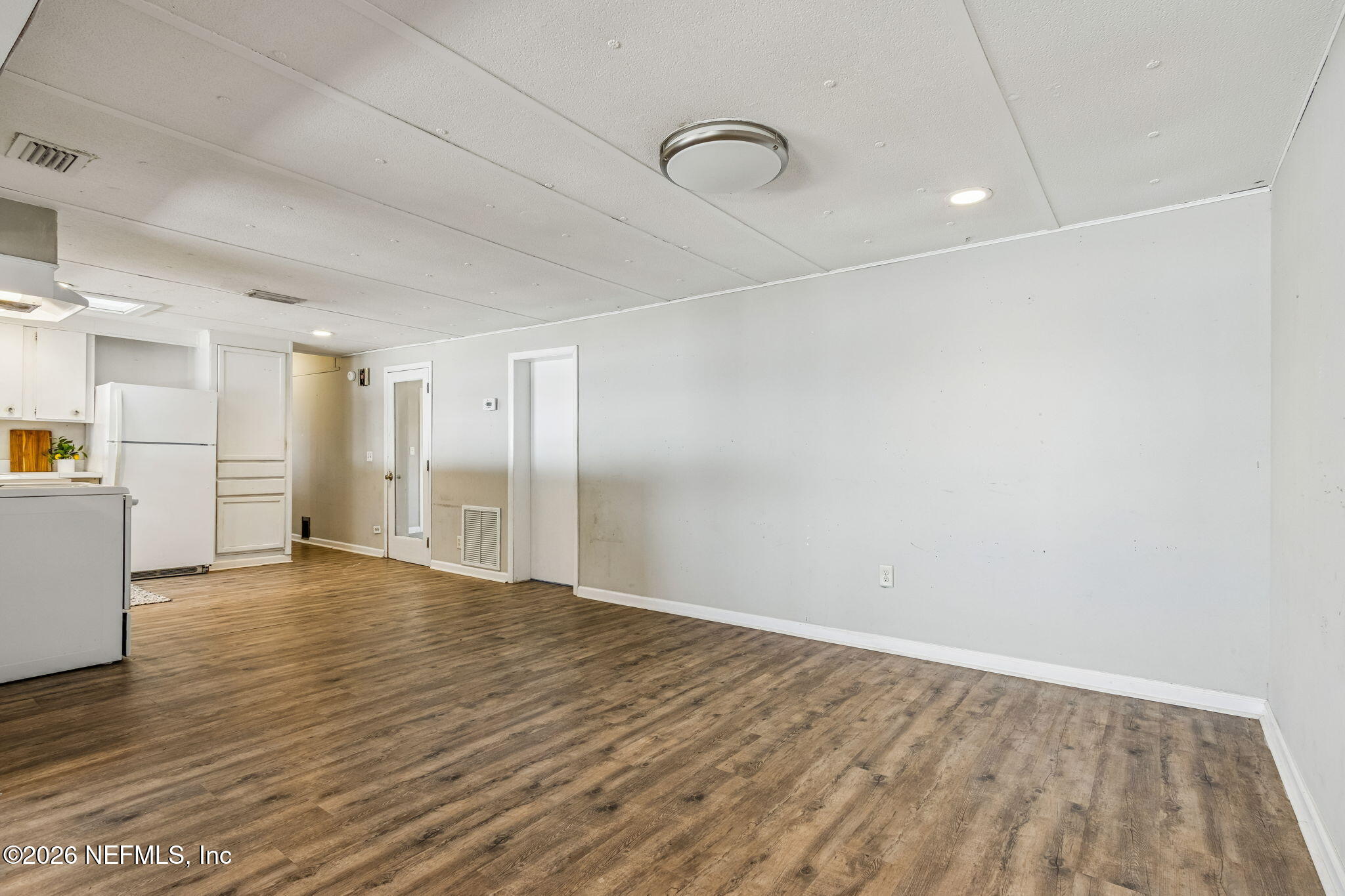8528 Moody Canal Road St. Augustine, FL 32092 - Photo 12 of 61 a view of an empty room with wooden floor