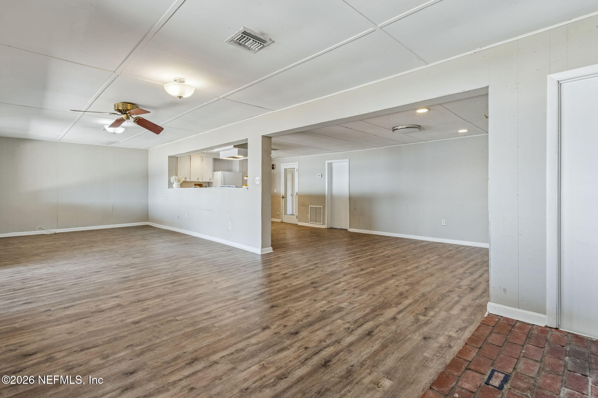 8528 Moody Canal Road St. Augustine, FL 32092 - Photo 15 of 61 an empty room with wooden floor and windows