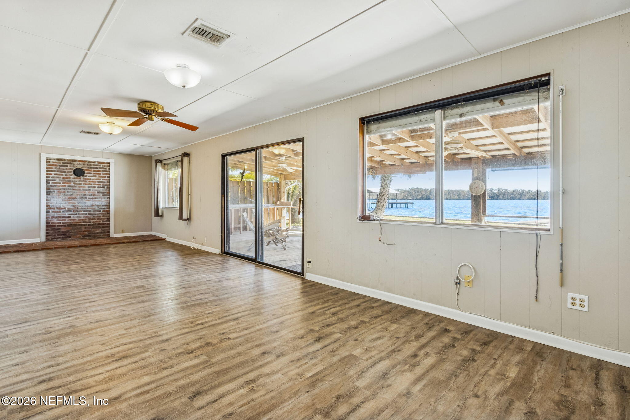 8528 Moody Canal Road St. Augustine, FL 32092 - Photo 17 of 61 a view of an empty room with a window and wooden floor