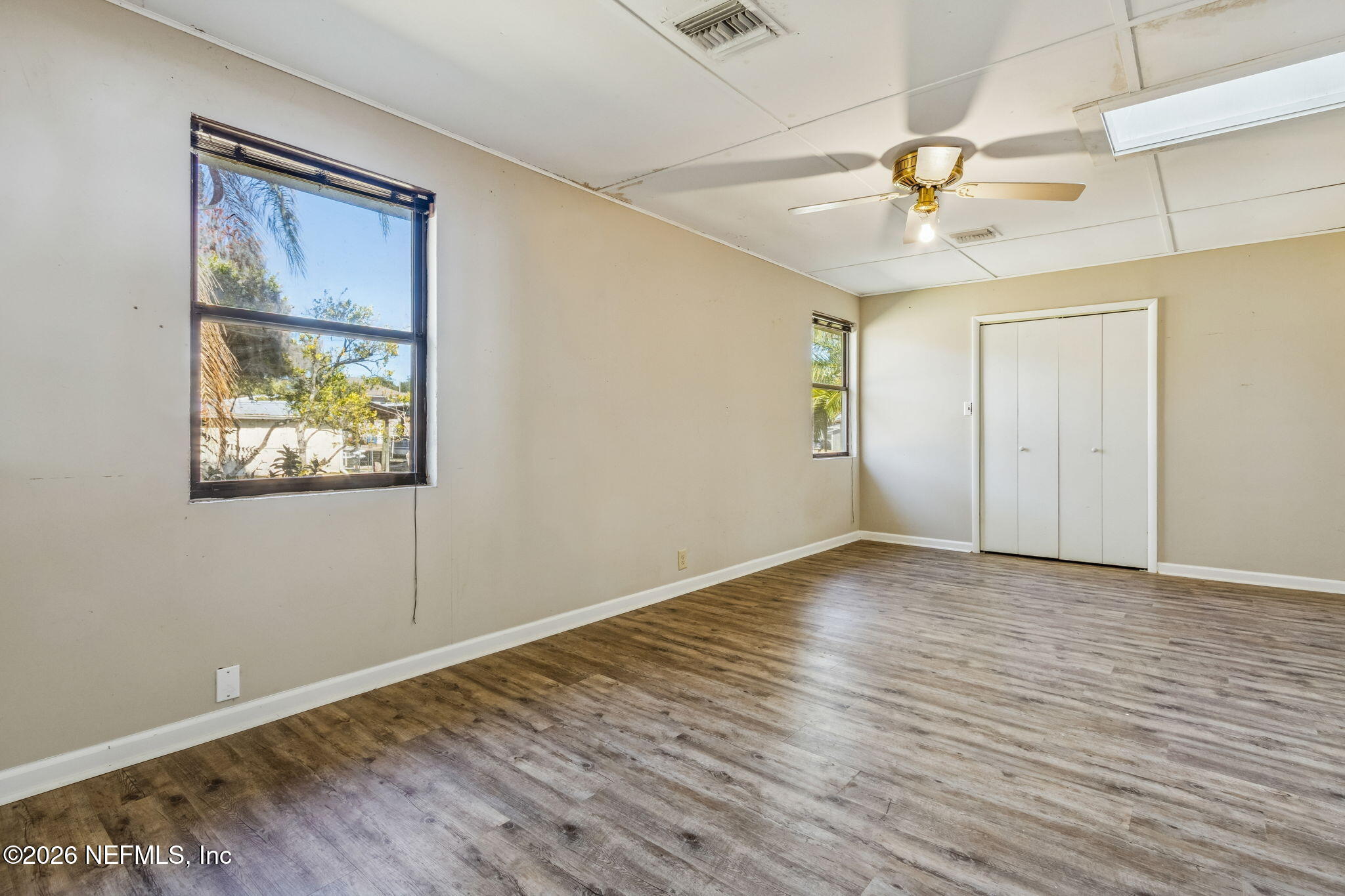 8528 Moody Canal Road St. Augustine, FL 32092 - Photo 25 of 61 an empty room with wooden floor fan and windows