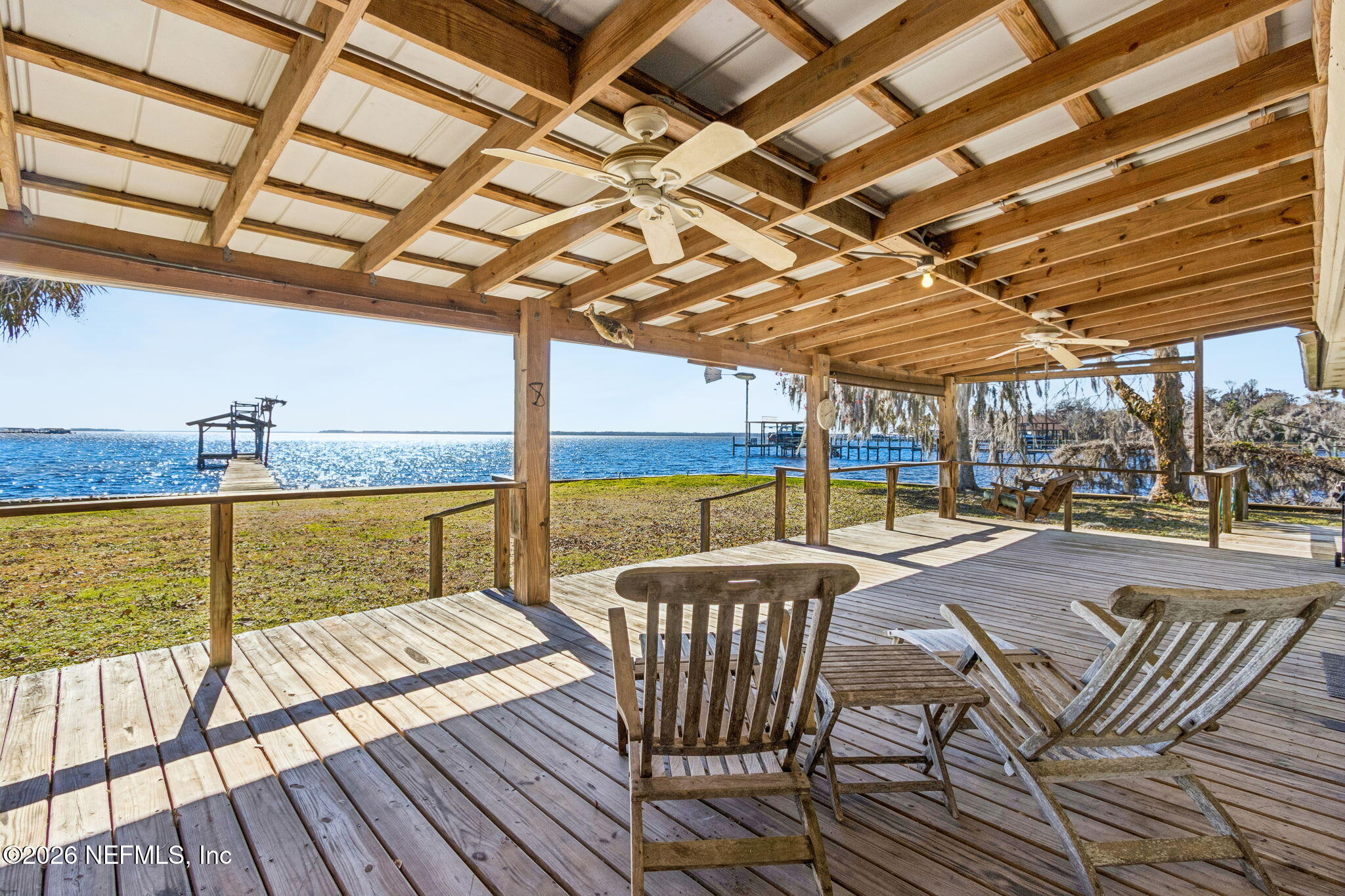 8528 Moody Canal Road St. Augustine, FL 32092 - Photo 30 of 61 a view of a swimming pool with a table and chairs