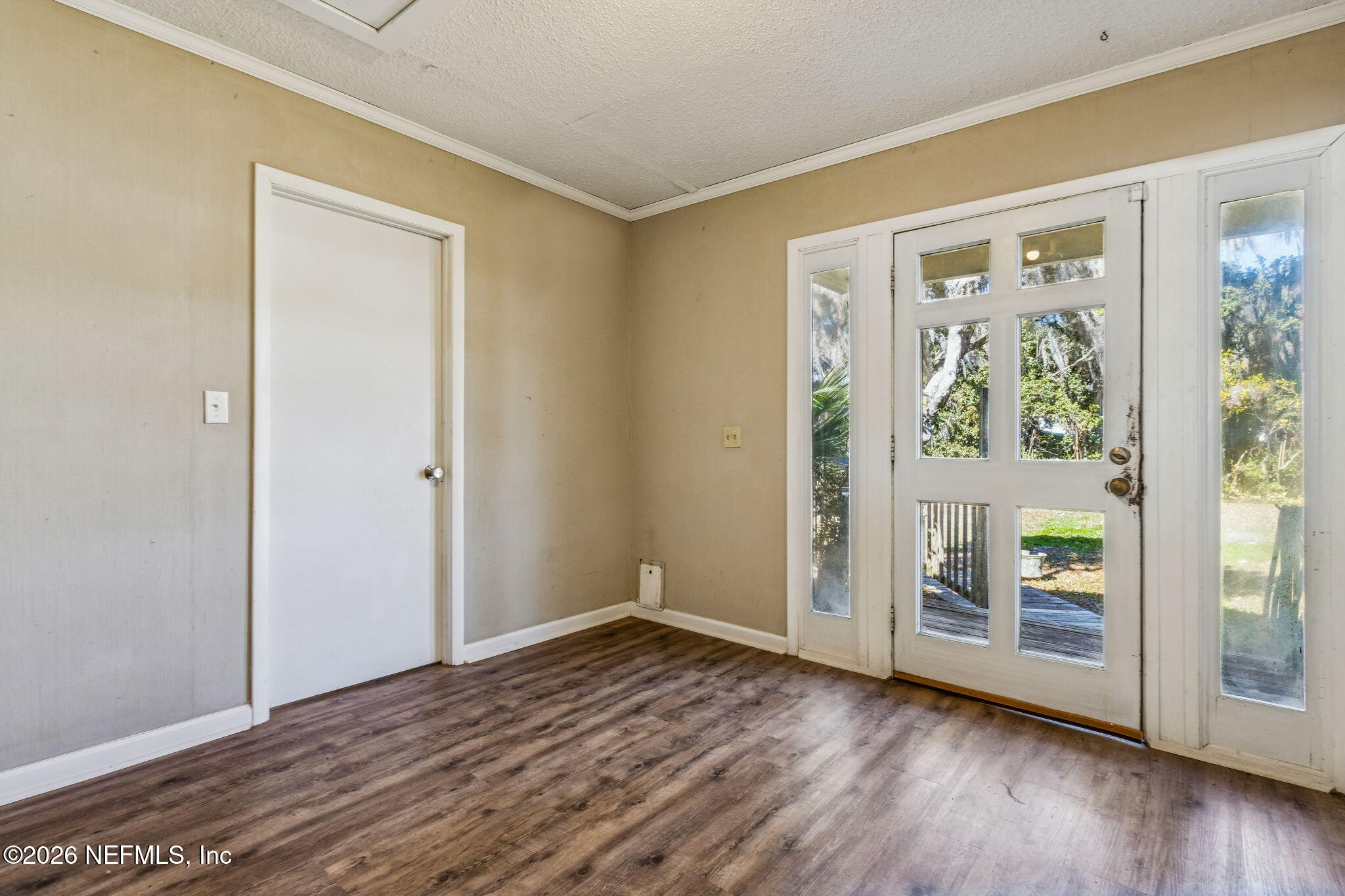 8528 Moody Canal Road St. Augustine, FL 32092 - Photo 5 of 61 an empty room with wooden floor and windows