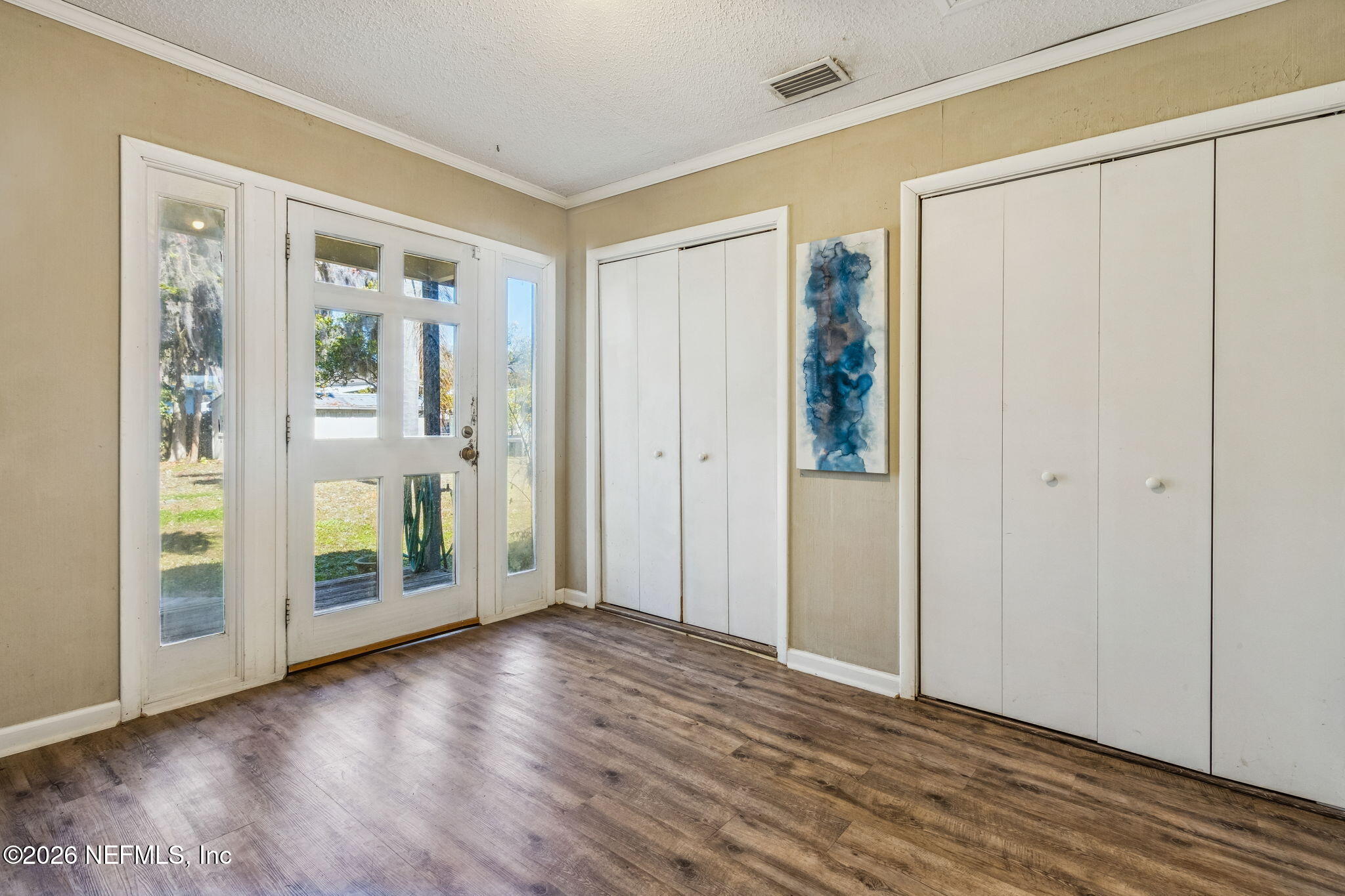 8528 Moody Canal Road St. Augustine, FL 32092 - Photo 60 of 61 an empty room with wooden floor and windows