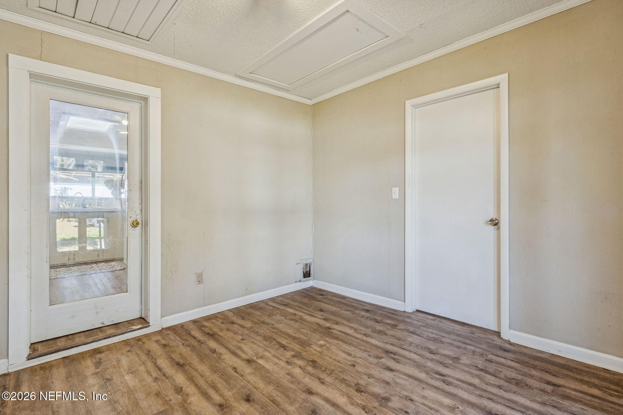 8528 Moody Canal Road St. Augustine, FL 32092 - Photo 6 of 61 a view of empty room with wooden floor and fan