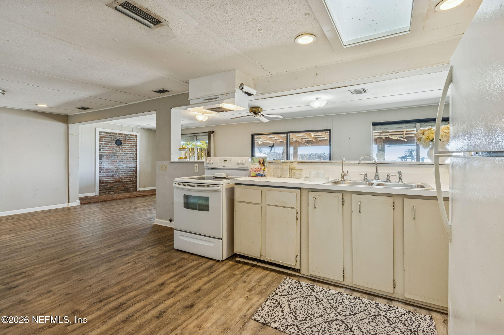 8528 Moody Canal Road St. Augustine, FL 32092 - Photo 7 of 61 a kitchen with white cabinets and sink