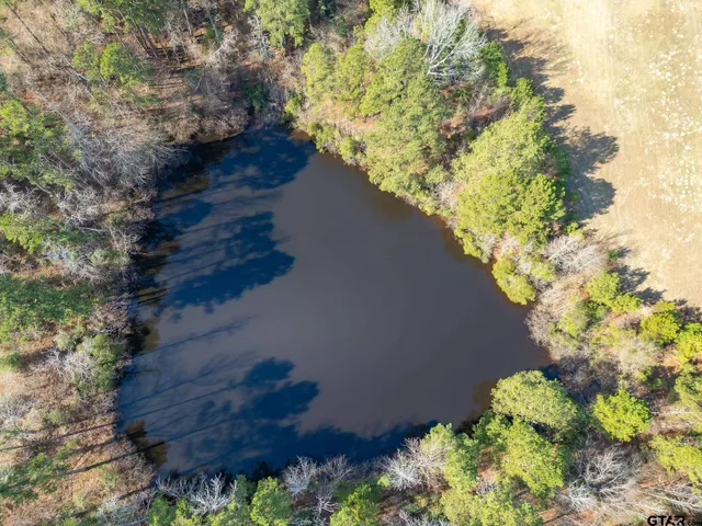 a view of a house with swimming pool and sitting area