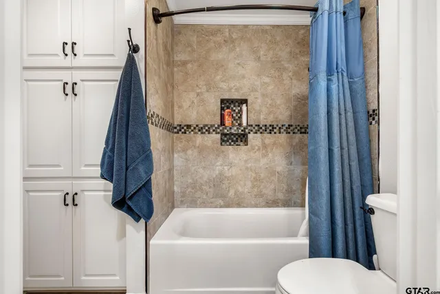 a aerial view of a house with a yard and large trees