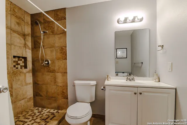 a bathroom with a sink toilet and shower