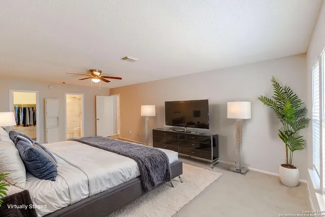 a bedroom with a bed and a television