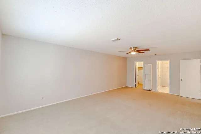 an empty room with windows and closet