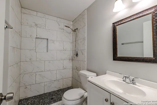 a bathroom with a sink toilet and shower