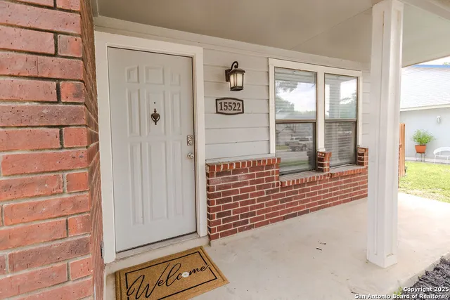 a view of a hallway with stairs and furniture