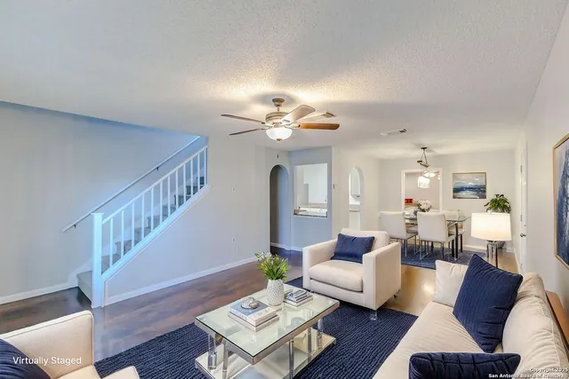 a living room with furniture and wooden floor