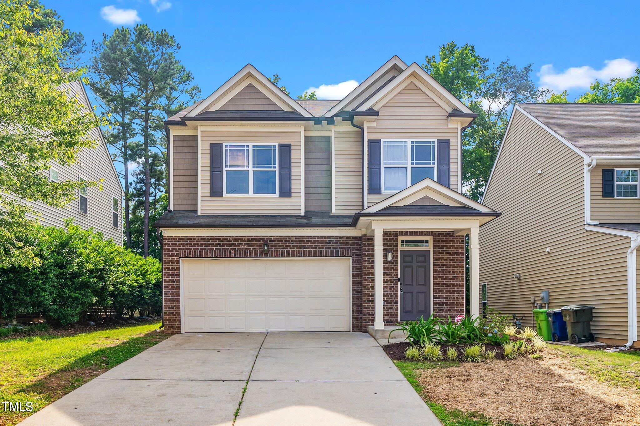 3213 Sunbright Lane Raleigh, NC 27610 - Photo 20 of 25 a front view of a house with garden