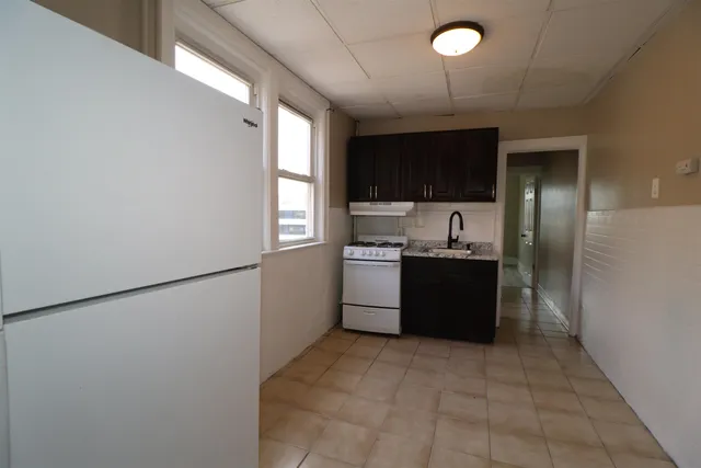 a kitchen with a refrigerator and a sink