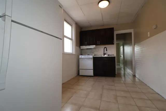 a kitchen with stainless steel appliances a refrigerator and a sink