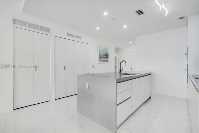 a kitchen with white cabinets