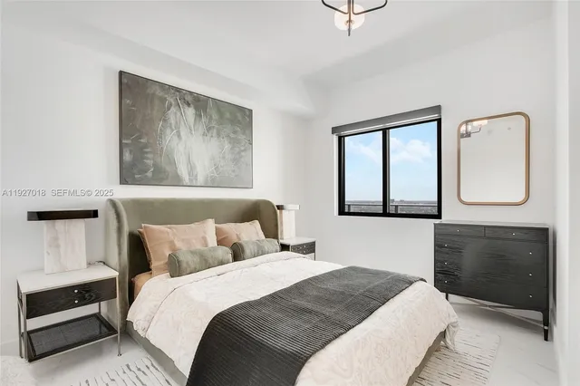 a bedroom with a bed and a dresser