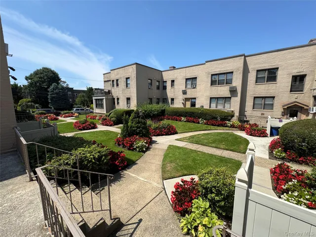a view of a patio with table and chairs potted plants