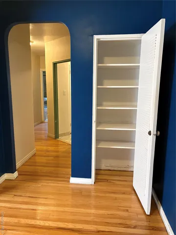 a view of walk in closet with empty racks