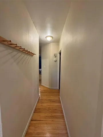 a view of hallway with wooden floor
