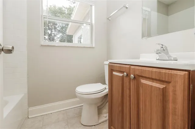 a bathroom with a toilet sink and vanity