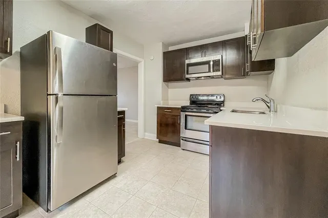 a kitchen with stainless steel appliances a refrigerator and a sink