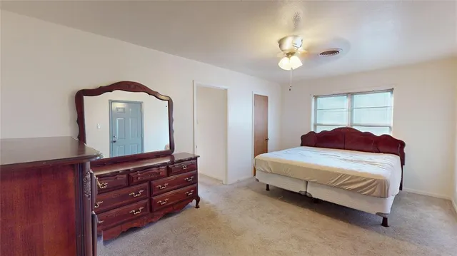 a bedroom with a bed and a dresser